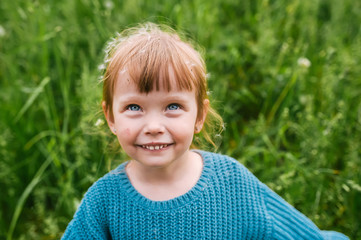 Outdoors portrait of cute little girl in summer day