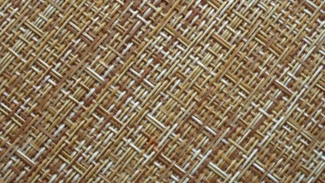 The texture of the fabric. Beige wicker fabric. Close-up. Can be used as a background.