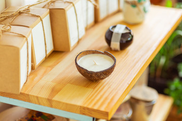 Candles of different shapes for sale in a shop.