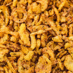 Crispy Fried Onion Strings Background. Selective focus.