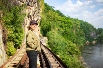 Asian female tourist standing on railway