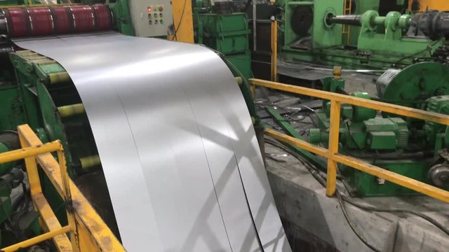 20-06-2019 Foshan, China - Metal working factory. Unwinding, cutting and winding metal coils in steel company