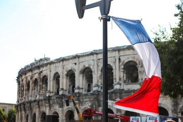 French flag and Roman coliseum at background