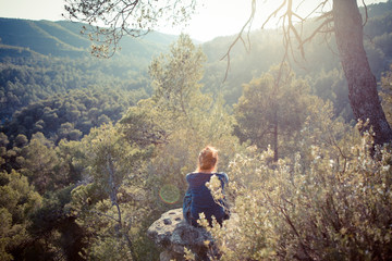 Girl looking at beautiful sunset in a forest. countryside