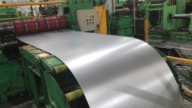 20-06-2019 Foshan, China - Metal working factory. Unwinding, cutting and winding metal coils in steel company