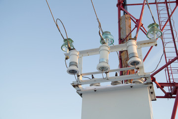 electric tower on a bright sunny day. On the front side of the server, switches and wiring are...
