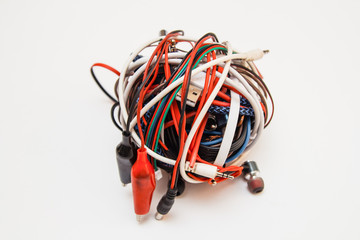 plugs, isolated on white background. A ball of colored wires. A ball of bright multi-color network cables and plugs