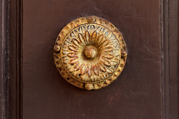 Antique rust door handle with a simple iron pattern
