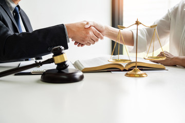 Handshake after cooperation between attorneys lawyer and clients discussing a contract agreement...