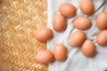 Brown eggs lay on a white plaid fabric. Healthy food concepts.
