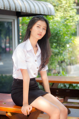 Portrait of thai adult student university uniform beautiful girl relax and smile