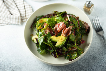 Healthy green salad with ham and avocado
