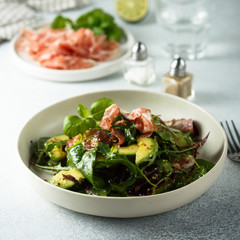 Healthy green salad with ham and avocado