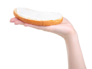 Bread with cream cheese processed in hand on white background isolation