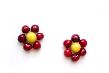Flower shaped fruit isolated on white background. Diet. Food. Cherries and plum.