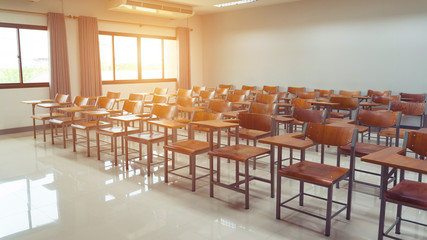 Empty university classroom with wooden chairs and desks. Modern university lecture room without student. Empty university classroom