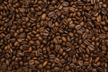 Roasted coffee beans brown seeds texture background wallpaper. Top view.