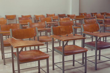 Empty university classroom with wooden chairs and desks. Modern university lecture room without student. Empty university classroom
