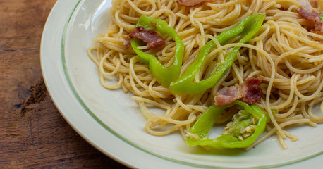 A dish of spaghetti on wooden table