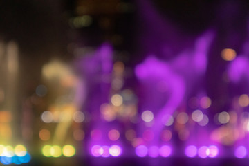 Defocused Blurred Abstract background of fountain light with colorful illuminations bokeh at night. Background Concept.