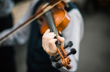 Art and artist. Young elegant man violinist violinist playing violin on black. Classical music. little boy musical instrument