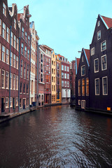 Fototapeta na wymiar Canal and buildings in Amsterdam.