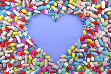 Heart frame of pills on blue