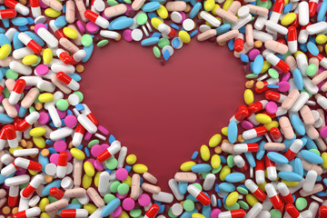 Fototapeta na wymiar Heart frame of pills on red
