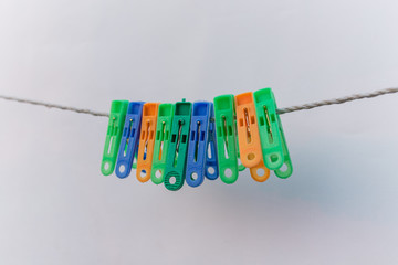 Colorful clothespins set. hang on the rope. isolated on white background with place for copy