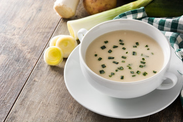 French vichyssoise soup in bowl on wooden table. Copyspace