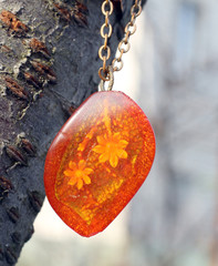 old pendant with flower in amber