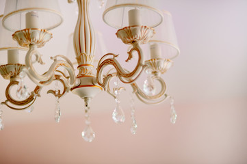 Beautiful Yellow and blue Light reflecting through brushed czech glass crystals hanging on vintage chandelier