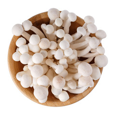 Fototapeta na wymiar Bunapi shimeji, white beech or white clamshell mushrooms in wooden bowl isolated on white. Top view.