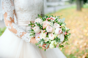 Diamond jewelry on a bridal bouquet.