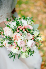 Diamond jewelry on a bridal bouquet.