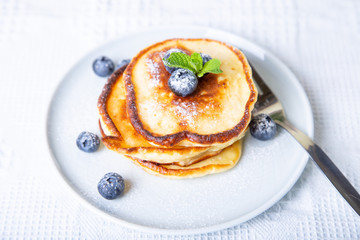 Cottage cheese pancakes (syrniki). Homemade cheesecakes from cottage cheese with berries. Traditional Russian dish. Close-up.