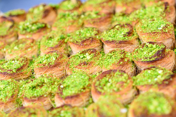 Honey Baklava Kadayif with nuts pistatio in the market. Beautiful arabic sweet background. Selective focus.