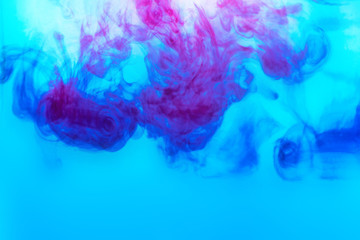 background of blue paint diluted in water on a light blue background