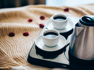 Morning breakfast with black coffee in bedroom.