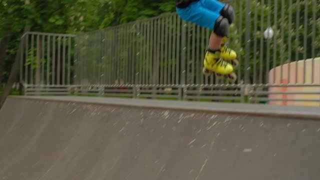 Champion rollerblader in training. Young confident boy performing trick on the ramp