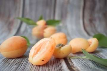Composition of ripe apricots on a wooden background
