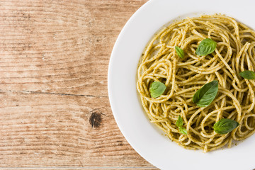 Spaghetti pasta with pesto sauce on wooden table