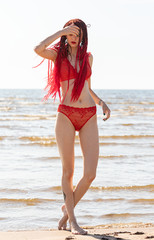girl in a red bathing suit on the beach