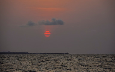Sunset with clouds on the seashore