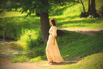 woman in a white dress in an summer park