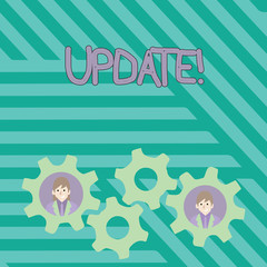 Writing note showing UPDATE. Business concept for make something more modern or up to date like software program Two Business People Inside Cog Wheel Gear for Teamwork Event