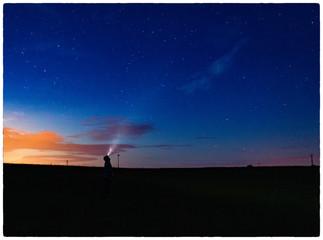 Fototapeta na wymiar silhouette of man on the background of blue sky