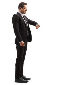Businessman in a suit looking at his wrist watch
