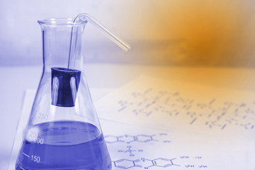 Laboratory test tube and chemical formula background , science concept.