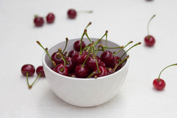 big cherry in a plate on a white background